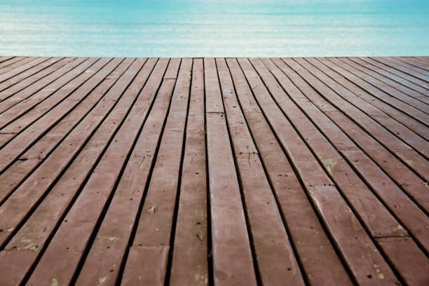 Old wood on beach with the sea background.