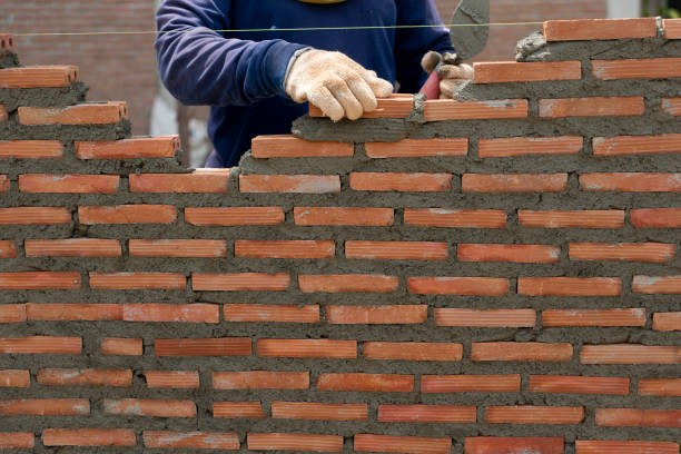 istock hand of professional construction worker laying bricks In wall construction, construction and masonry concept 1222693035