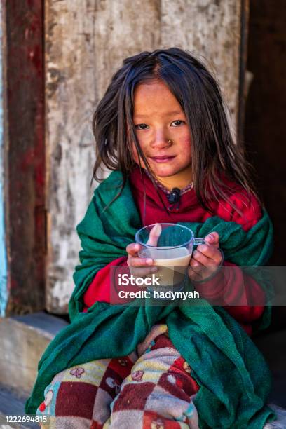 Portrait Of Little Girl Drinking Milk Tea Mount Everest National Park Nepal Stock Photo - Download Image Now