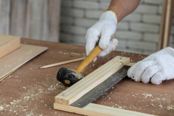 Carpenter working on wood craft at workshop to produce construction material or wooden furniture. The young Asian carpenter use professional tools for crafting. DIY maker and carpentry work concept.