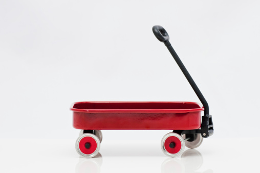 A close-up of a red toy cart.