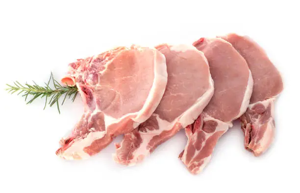 pork chops in front of white background