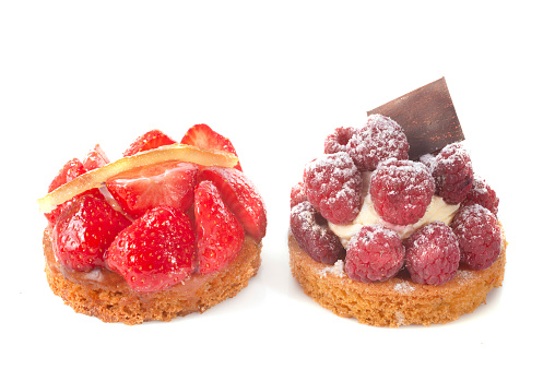 strawberry and raspberry tart in front of white background