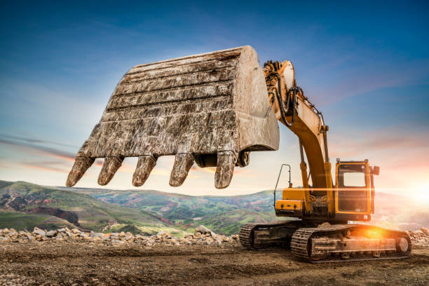istock Excavator at a construction site against sunset 1222703720