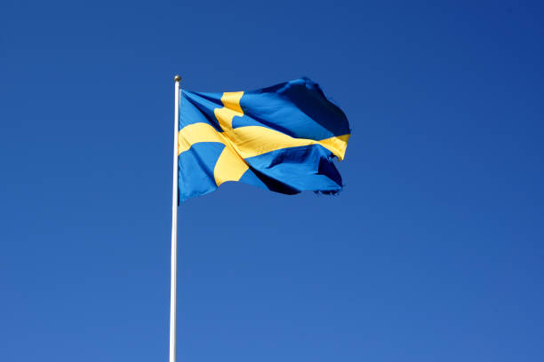 sweden flag waving against the clear blue sky - day sky swedish flag banner imagens e fotografias de stock