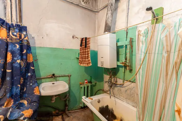 Old and dirty bathroom in the  apartment that is prepared to demolition  is the  place for refugees for temporary period of  living  and existence.
