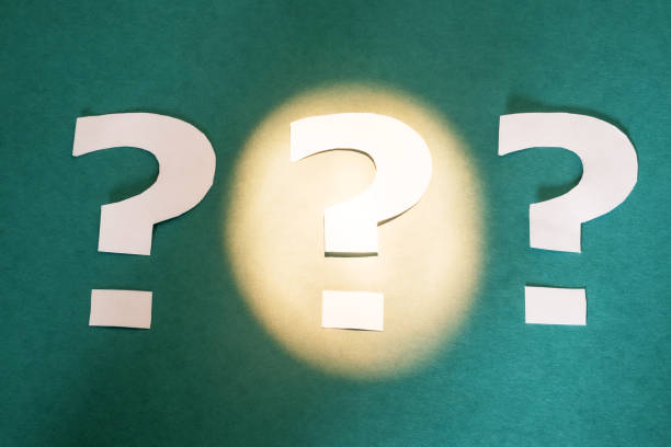 istock three question marks cut out of paper are on a paper background 1222711976