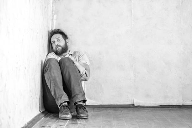 istock a crazy man with a beard hid in a corner in his old room 1222712012