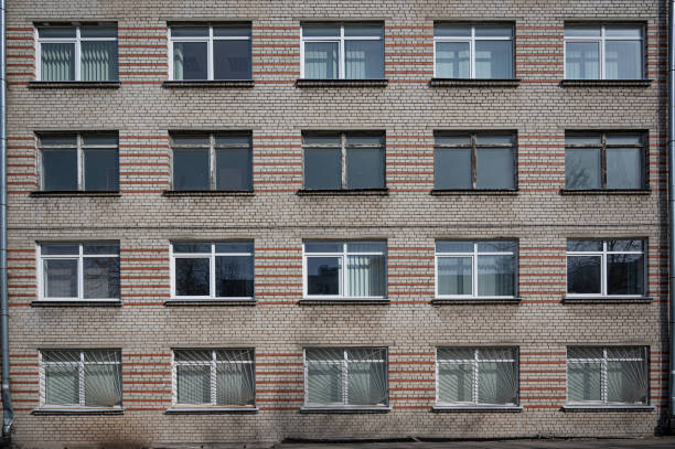 istock Facade of the Soviet panel grey with orange old building with windows 1222715947