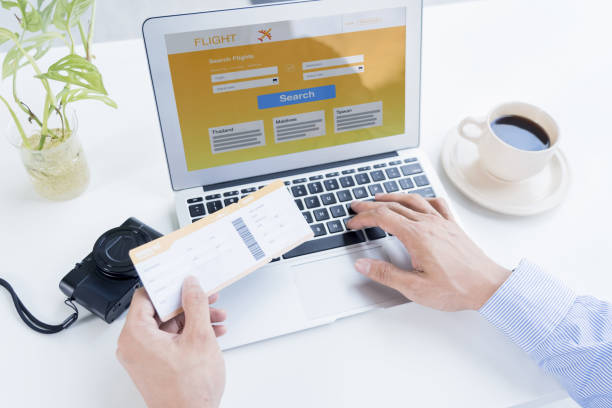 istock Man with a boarding pass searching for flights 1222718722