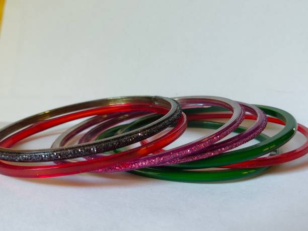 istock Bangles on white background. Indian traditional ornaments image. Colorful bangles on plain background. Symbol of married woman. 1222720397