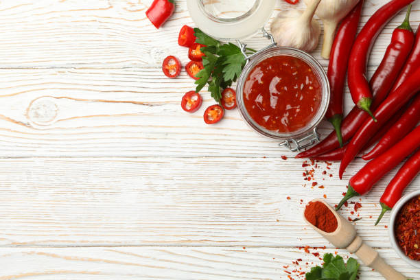 istock Composition with red hot sauce and ingredients on wooden background 1222720597