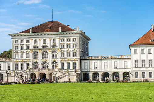 Munich, Germany - September 8th, 2018: A group of tourists visit the Nymphenburg Palace (Schloss Nymphenburg - Castle of the Nymphs) The palace was the main summer residence of the former rulers of Bavaria of the House of Wittelsbach.
