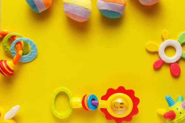 istock Colorful and various plastic toys for babies on a yellow background. Layout. Empty space for the text. Minimalism 1222721795