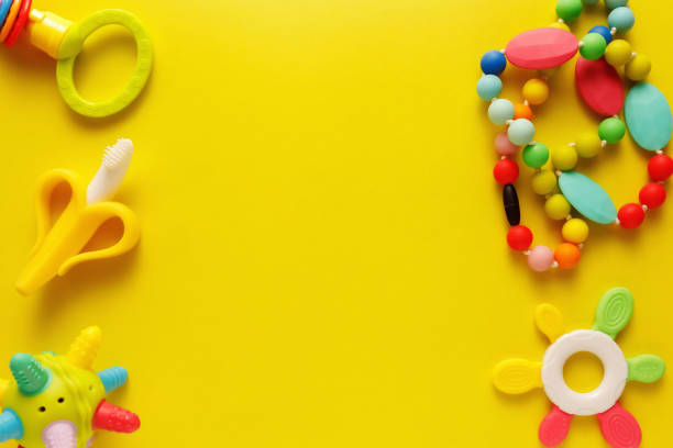 istock Colorful and various plastic toys for babies on a yellow background. Layout. Empty space for the text. Minimalism 1222722085