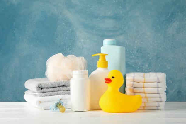 istock Baby hygiene accessories on wooden table against blue background 1222723418