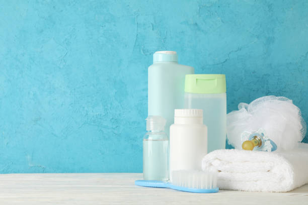 istock Baby hygiene accessories on wooden table against blue background 1222723628