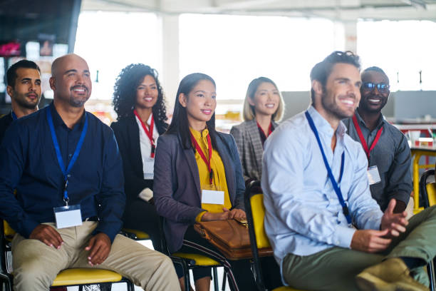 istock Smiling professionals listening in seminar 1222725316