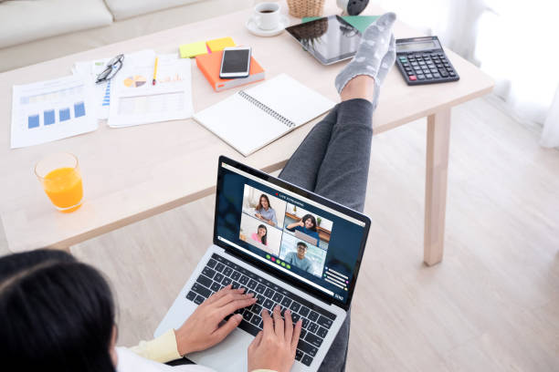 istock asian woman work from home with video conference app collaboration with colleagues with business chart on tablet.live streaming meeting.protect risk of being exposed to coronavirus (covid-19) 1222725344
