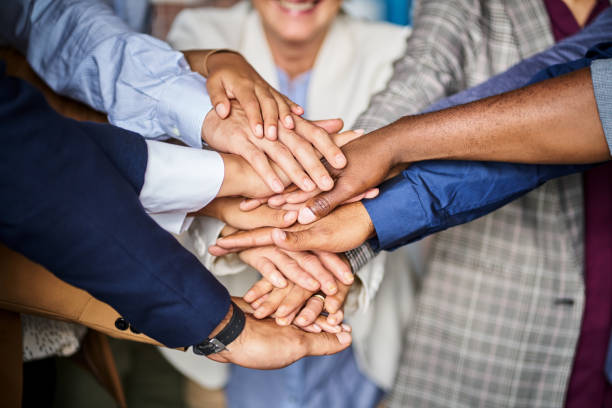 istock male and female executives stacking hands at office 1222725462