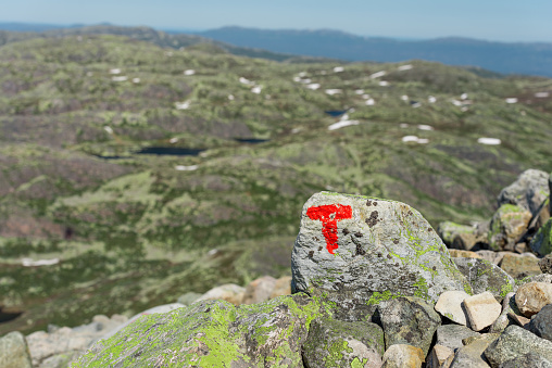 Signs of the Norwegian Trekking Association (Den norske turistforening, DNT) on the path to Gaustatoppen mountain (Norway)