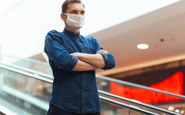 istock man in a protective mask standing on the steps of the subway escalator 1222730792