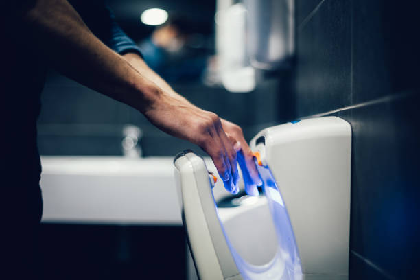 close up. man disinfecting his hands in the bathroom stock photo