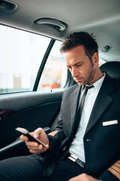 istock business man text messaging in the taxi 1222732068