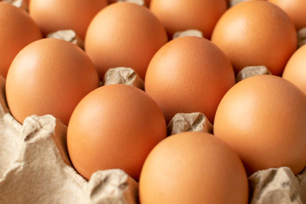 istock Brown egg in paper packaging. Container for eggs. Recycling. Healthy rustic breakfast 1222732214