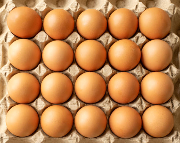 istock Brown egg in paper packaging. Container for eggs. Recycling. Healthy rustic breakfast 1222732226