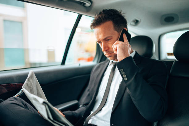 istock business man text messaging in the taxi 1222732289