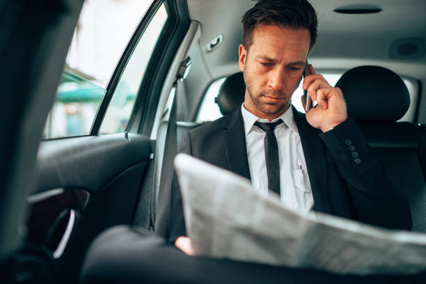 istock business man text messaging in the taxi 1222732382