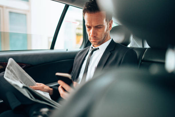 istock business man text messaging in the taxi 1222732485
