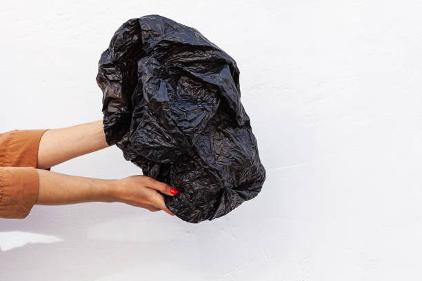 istock Concept of stop plastic pollution, global warming, recycling plastic, plastic free. Hand holding a plastic bag on a white background 1222733949