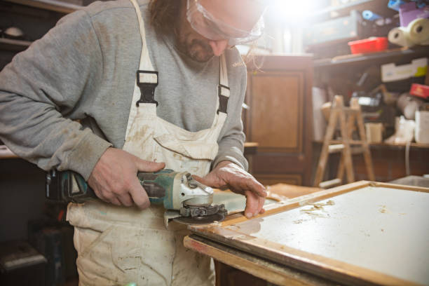 istock Male carpenter working on old wood in a retro vintage workshop. 1222734159