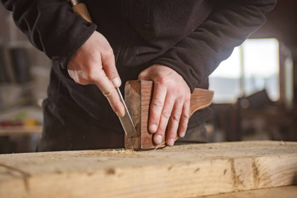 istock Male carpenter working on old wood in a retro vintage workshop. 1222734266