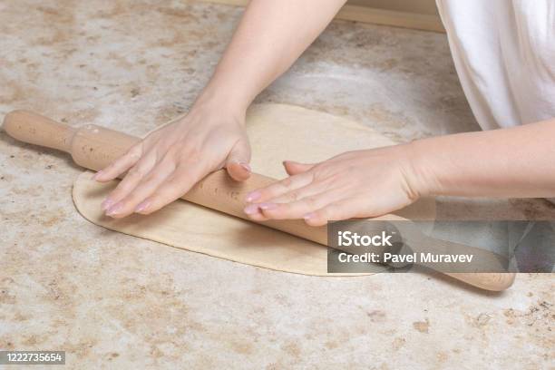 Closeup Image Of Young Woman Rolling Dough With Wooden Rolling Pin Cook At Homemaking A Pizza At Home With Tomato And Cheese Quarantine Stock Photo - Download Image Now
