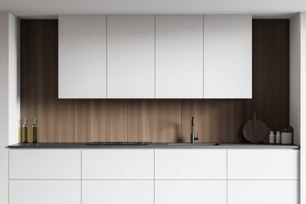 istock White countertops and cupboards in wooden kitchen 1222736141
