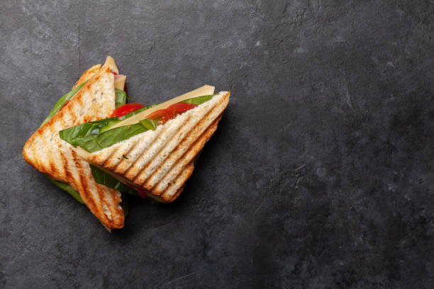 istock Club sandwich with ham, cheese, salad and vegetables 1222737436