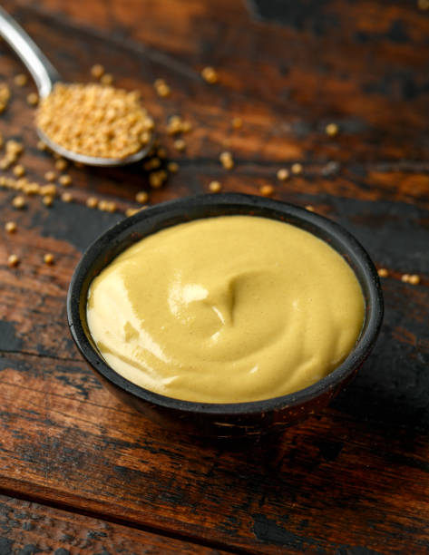 istock Dijon mustard in bowl on wooden table. 1222741034