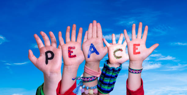 istock Children Hands Building Word Peace, Blue Sky 1222741683