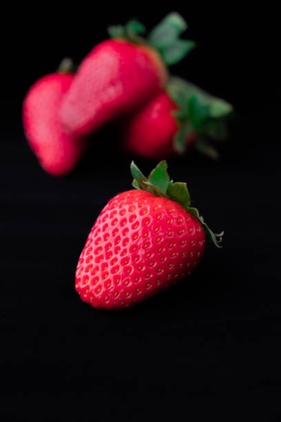 istock Strawberries with strawberry leaf on black background 1222742360
