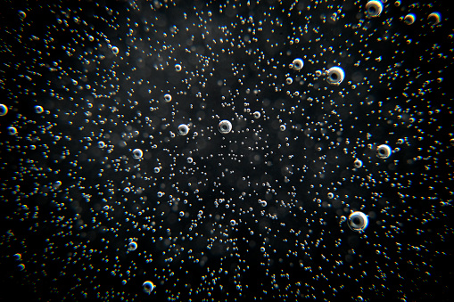 Black abstract background with bubbles. Air bubbles texture.