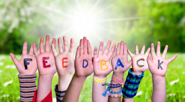 istock Children Hands Building Word Feedback, Grass Meadow 1222742501