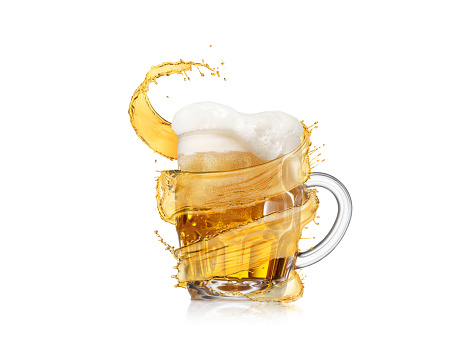 Flying spiral splash of light amber beer around full glass mug of fresh beverage with thick foam on a white background, copy space.