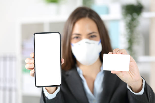 istock Executive shows blank phone and card avoiding covid-19 at office 1222744542