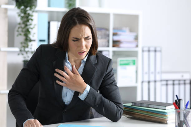 istock Ill executive suffocating at night in the office 1222745209