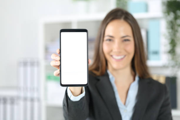 istock Happy executive showing blank phone screen at office 1222745248