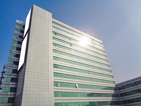 Diagonal view of Building with blank billboard with lens-flare reflection