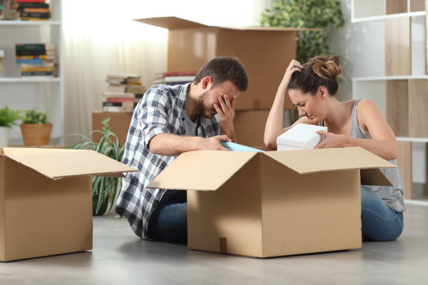 istock Sad evicted tenants moving home boxing belongings 1222745452